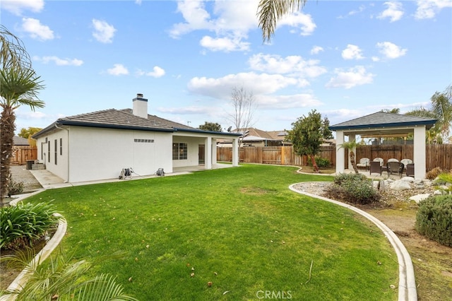 view of yard featuring a gazebo, a fenced backyard, and a patio