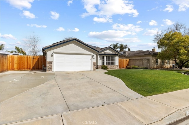 ranch-style home with an attached garage, fence, stone siding, and stucco siding