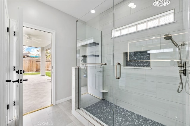 bathroom with tile patterned floors, baseboards, and a stall shower