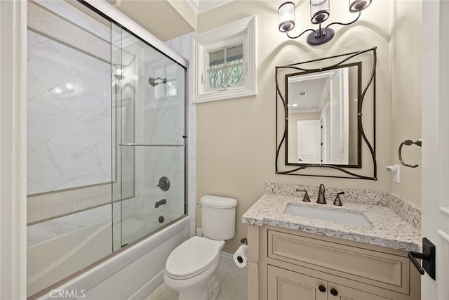 full bath featuring vanity, toilet, and bath / shower combo with glass door