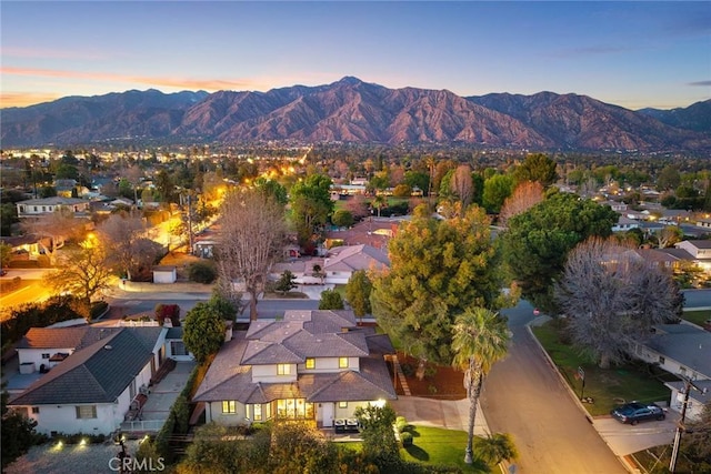 aerial view at dusk with a mountain view and a residential view