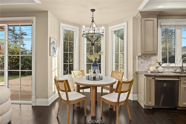 dining room with dark wood-type flooring, baseboards, and a chandelier