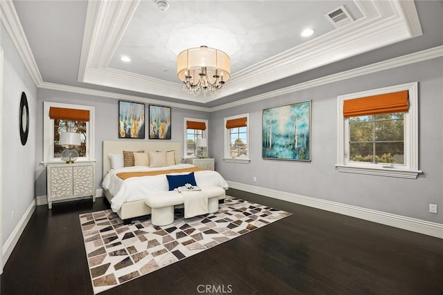 bedroom featuring visible vents, a tray ceiling, dark wood finished floors, an inviting chandelier, and baseboards