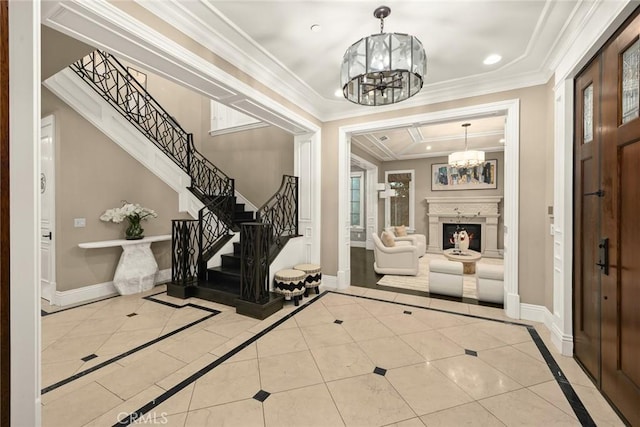 tiled foyer with a tray ceiling, a notable chandelier, baseboards, and ornamental molding