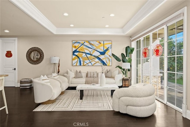 living room featuring recessed lighting, a raised ceiling, dark wood-type flooring, and ornamental molding