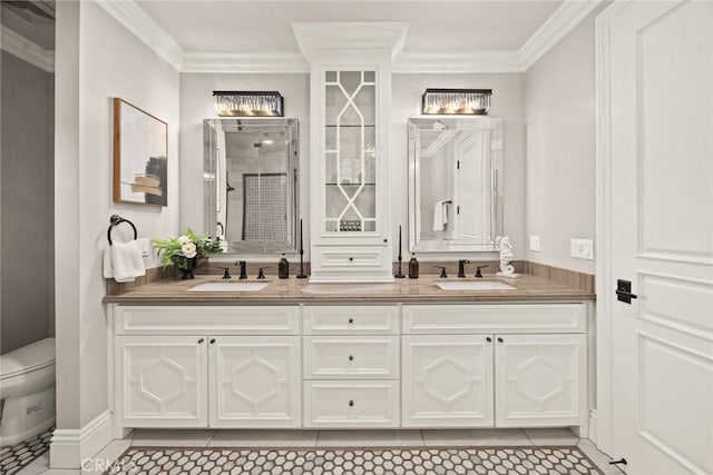 bathroom with a sink, ornamental molding, double vanity, and tile patterned floors