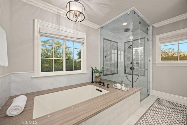 bathroom featuring a stall shower, an inviting chandelier, crown molding, baseboards, and a bath