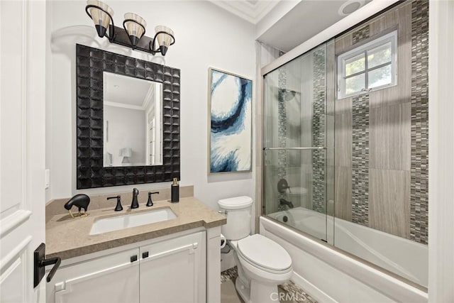 bathroom with bath / shower combo with glass door, toilet, vanity, and crown molding