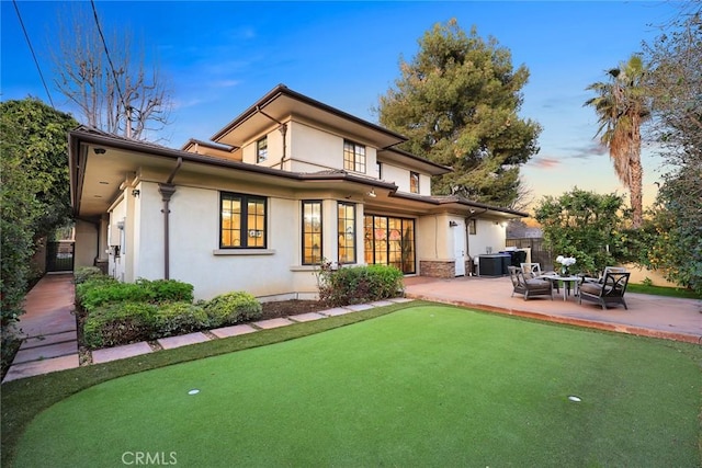 rear view of property with a patio area, stucco siding, cooling unit, and fence