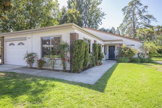 view of front of house featuring stucco siding, an attached garage, and a front lawn