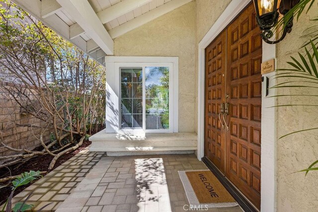 entrance to property featuring stucco siding