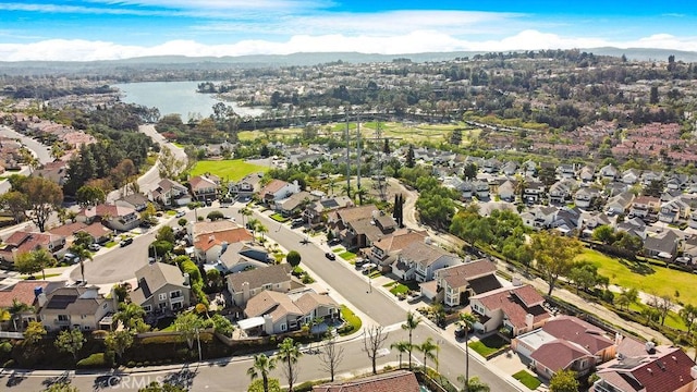 drone / aerial view with a residential view and a water view