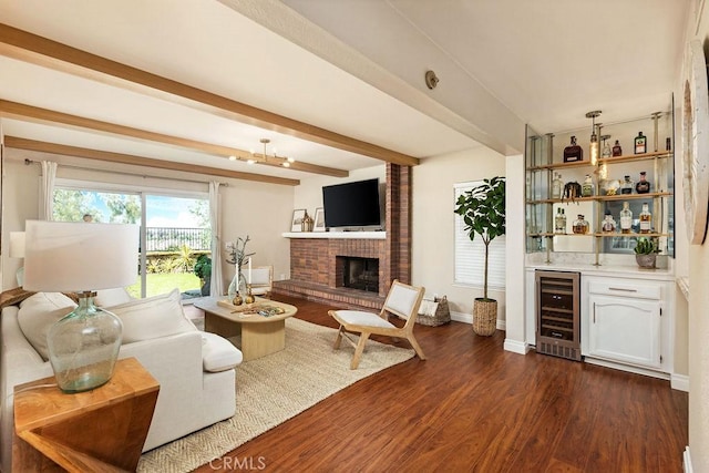 living area with a bar, beam ceiling, beverage cooler, and dark wood finished floors