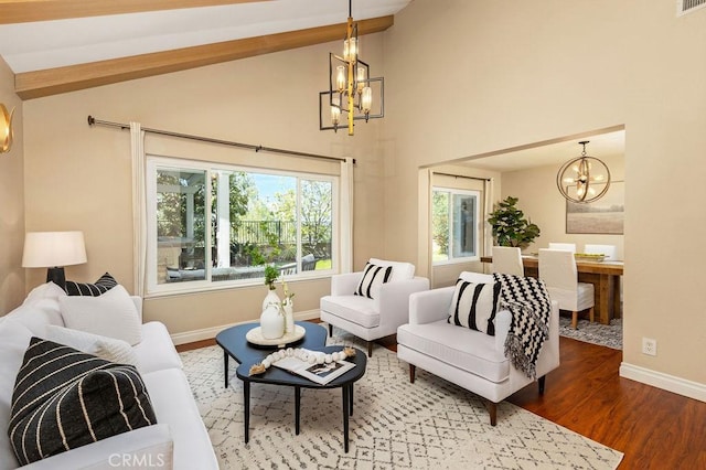 living room featuring high vaulted ceiling, wood finished floors, baseboards, and a chandelier