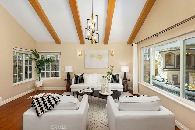 living room with vaulted ceiling with beams, wood finished floors, plenty of natural light, and baseboards