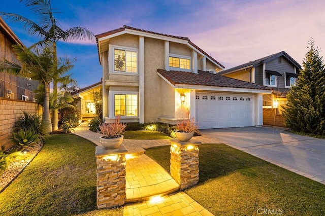 traditional-style house with stucco siding, driveway, fence, a garage, and a tiled roof