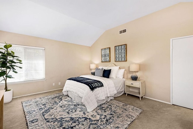 bedroom featuring lofted ceiling, baseboards, visible vents, and carpet floors