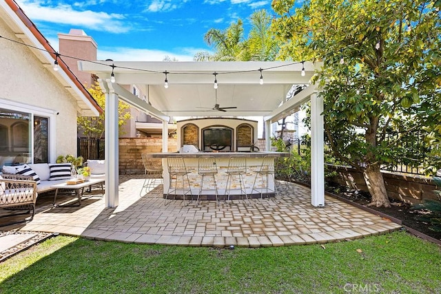 view of patio with outdoor dry bar, ceiling fan, outdoor lounge area, and fence