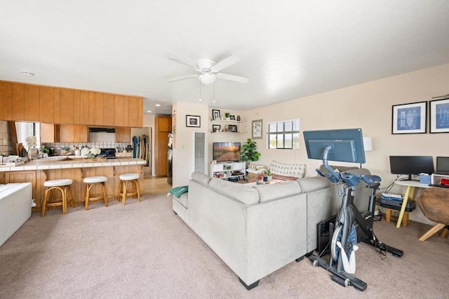 living room with ceiling fan and light carpet