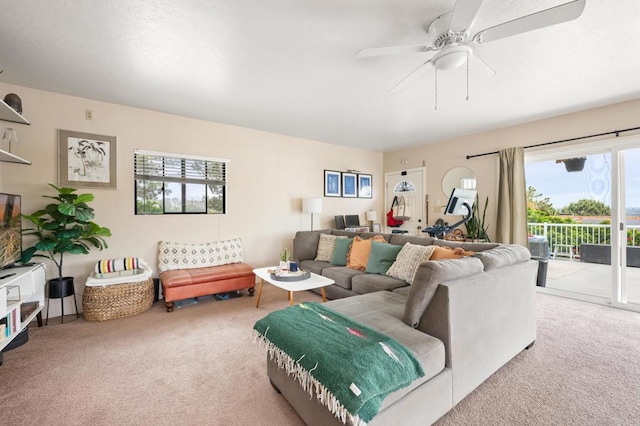 carpeted living room featuring ceiling fan