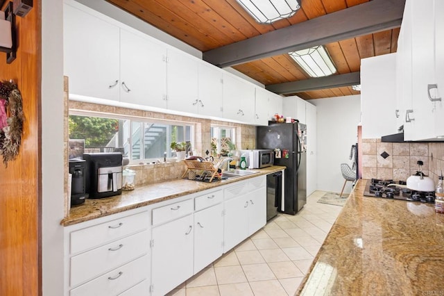 kitchen featuring beamed ceiling, black appliances, a sink, backsplash, and light tile patterned floors