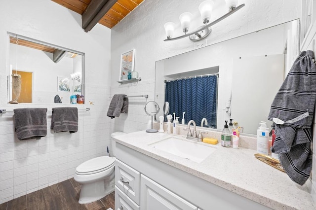 full bathroom featuring beamed ceiling, toilet, wood finished floors, tile walls, and wooden ceiling