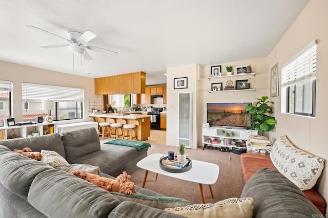 living room with light carpet and ceiling fan