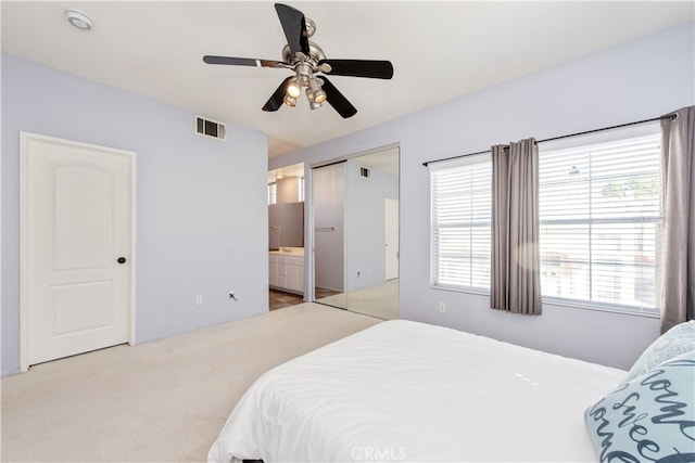 bedroom featuring visible vents, ceiling fan, connected bathroom, and carpet