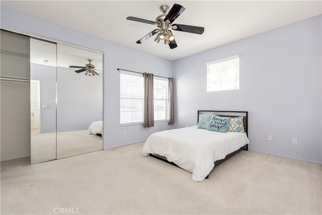 bedroom with a closet, ceiling fan, and carpet