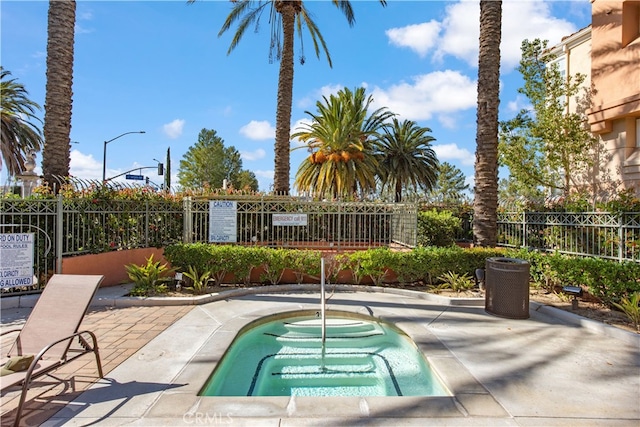 view of swimming pool featuring a patio and fence