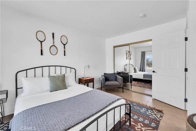 tiled bedroom featuring a closet