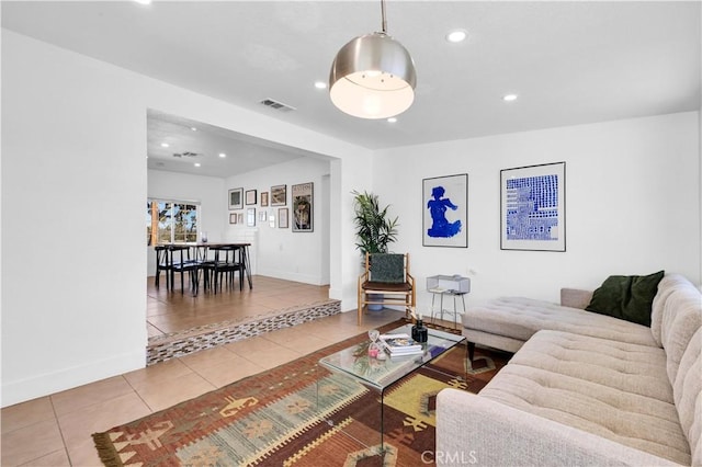 living area with recessed lighting, visible vents, baseboards, and tile patterned flooring