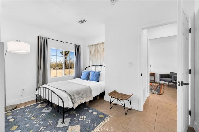 tiled bedroom with visible vents and baseboards