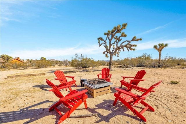 view of yard with an outdoor fire pit