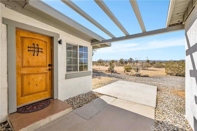 property entrance with stucco siding