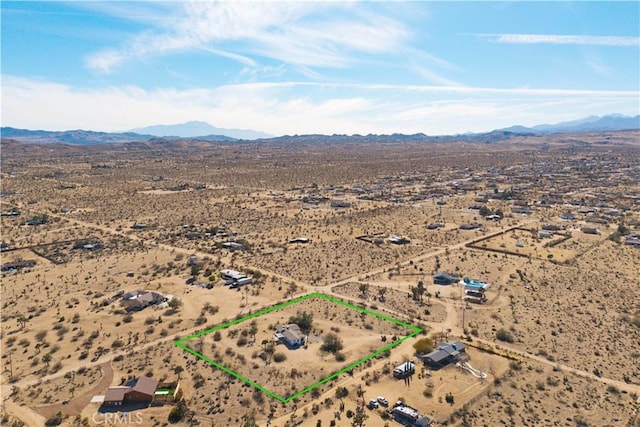 bird's eye view with a mountain view, a rural view, and view of desert