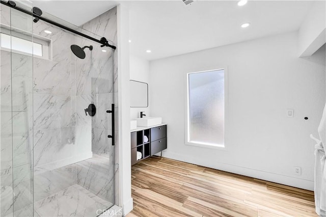 full bath with vanity, recessed lighting, wood finished floors, and a marble finish shower