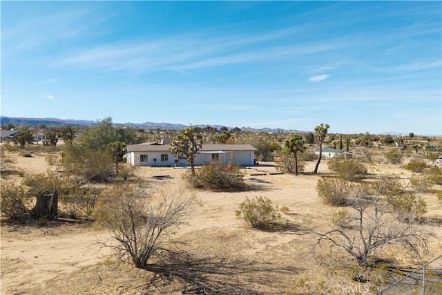 view of front of home with an attached garage, a mountain view, and driveway