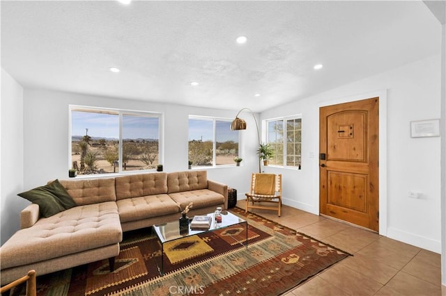 tiled living room featuring plenty of natural light, recessed lighting, baseboards, and a textured ceiling