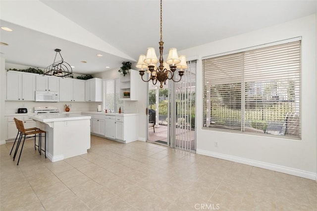 kitchen with open shelves, a kitchen island, white appliances, light countertops, and lofted ceiling