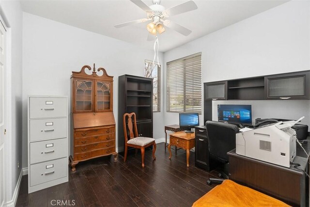 home office featuring dark wood finished floors, baseboards, and ceiling fan