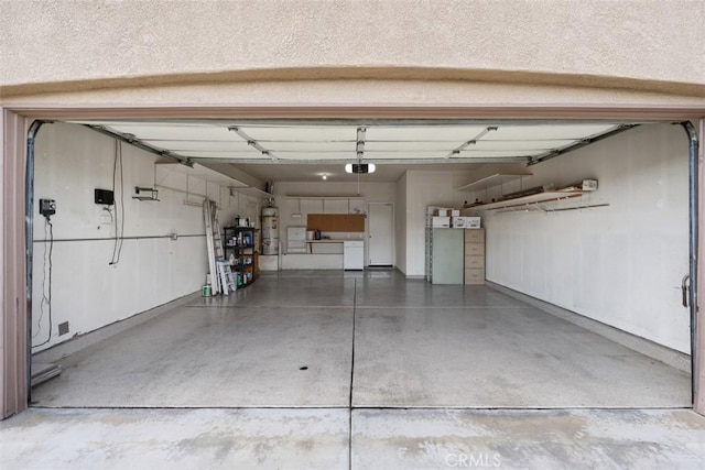 garage featuring strapped water heater and a garage door opener