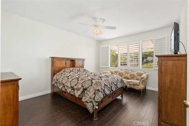 bedroom featuring baseboards, dark wood-type flooring, and a ceiling fan