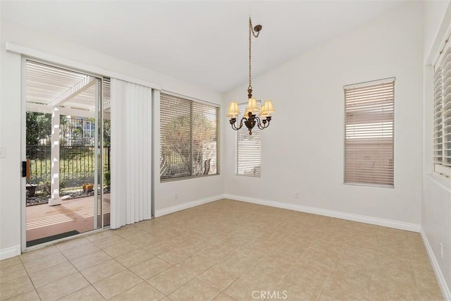 spare room with a wealth of natural light, an inviting chandelier, and vaulted ceiling