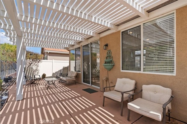 view of patio with a pergola and fence