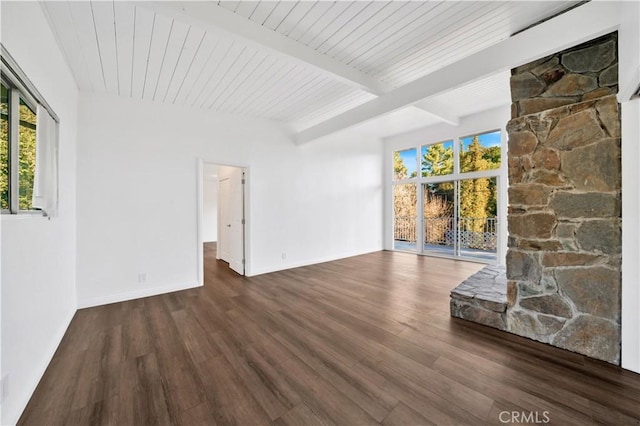 unfurnished living room featuring plenty of natural light, beamed ceiling, and wood finished floors