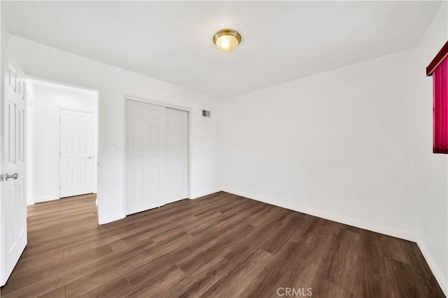 9970 Shadow Hills Dr, Sunland, CA 91040 - unfurnished bedroom with baseboards, dark wood-type flooring, a closet, and visible vents