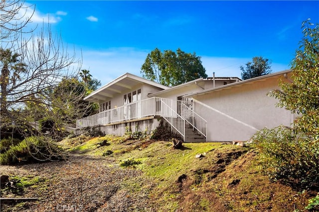 9970 Shadow Hills Dr, Sunland, CA 91040 - view of side of home featuring stucco siding and stairs
