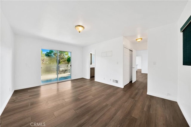 9970 Shadow Hills Dr, Sunland, CA 91040 - unfurnished living room featuring baseboards, dark wood-type flooring, and visible vents