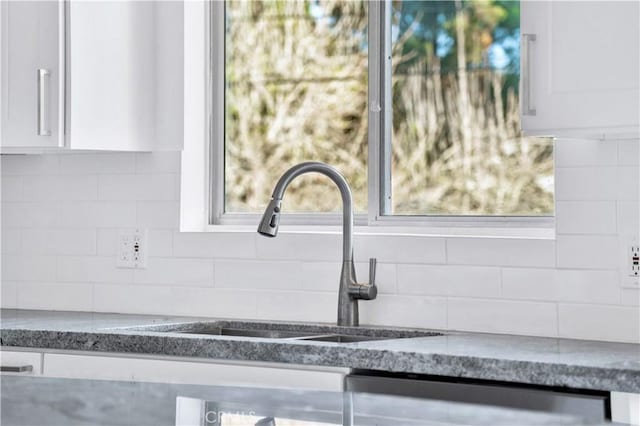 9970 Shadow Hills Dr, Sunland, CA 91040 - details with dark stone counters, white cabinetry, decorative backsplash, and a sink